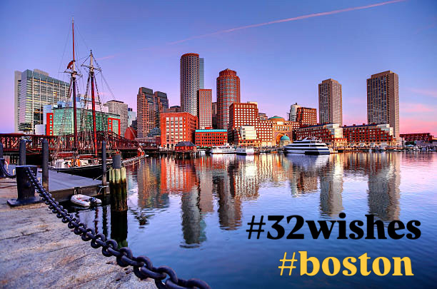 Boston harbor and skyline at dusk, labeled #32wishes #boston