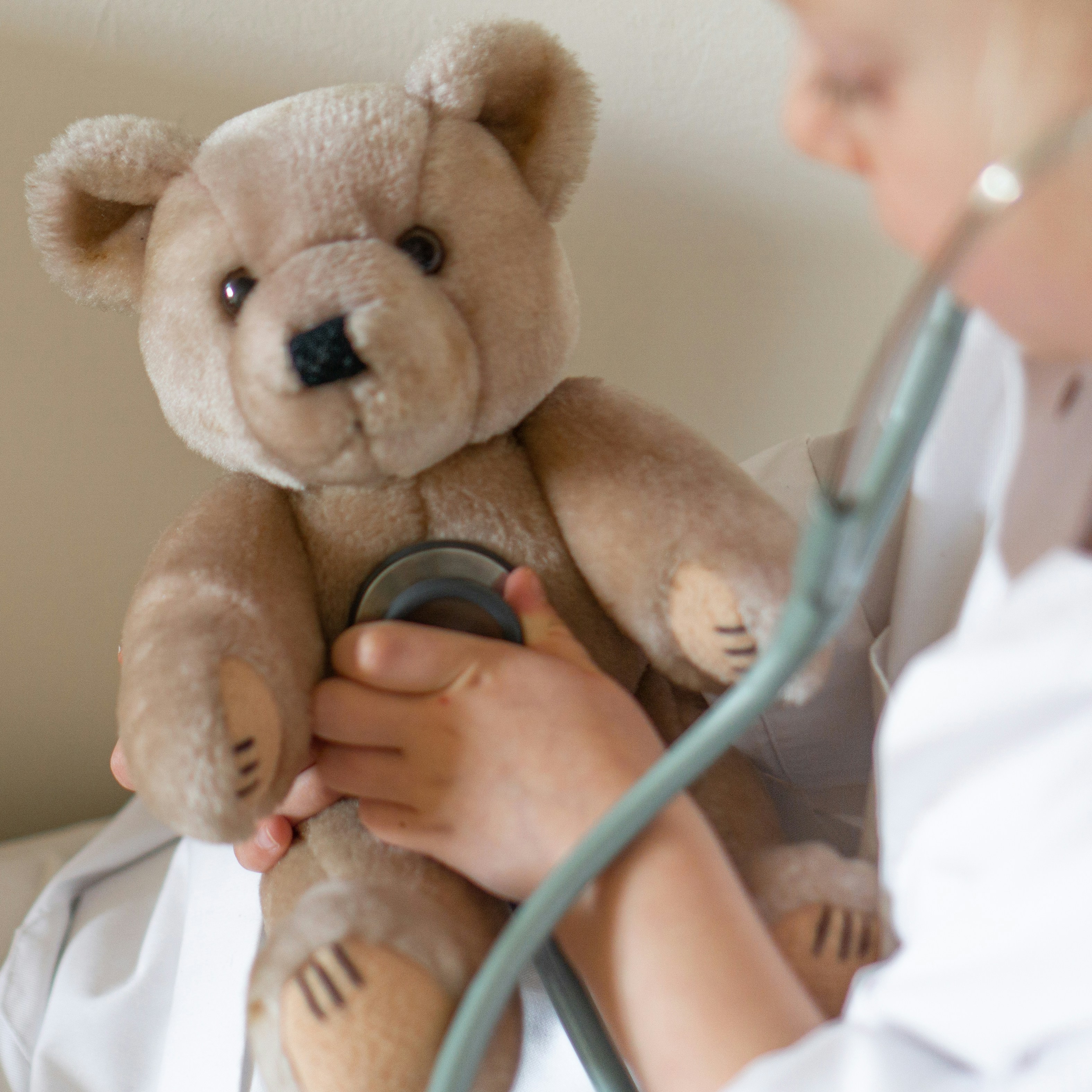 Pediatrician caring for stuffed teddy bear during pediatric care
