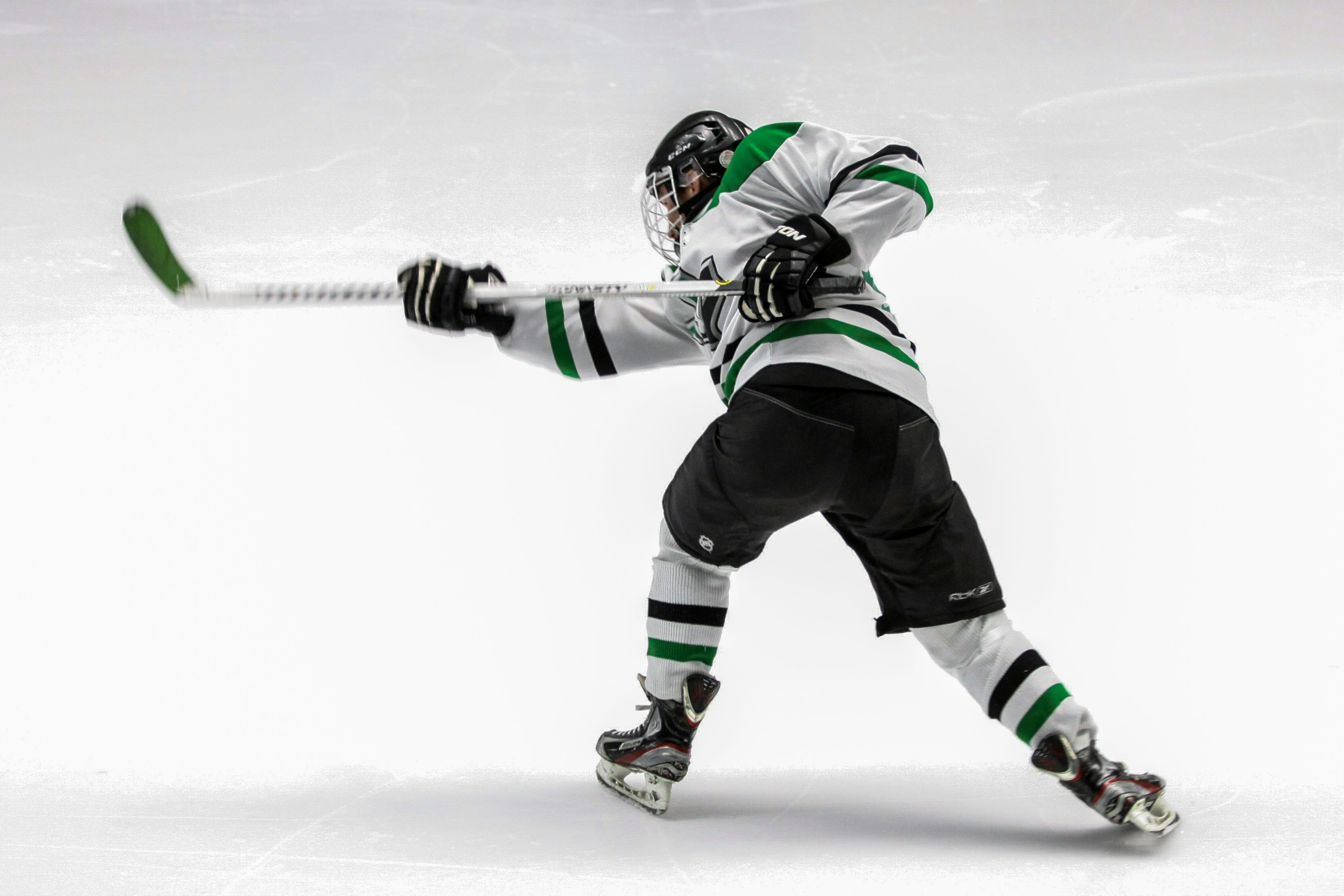 Hockey player shooting a puck for a potential goal